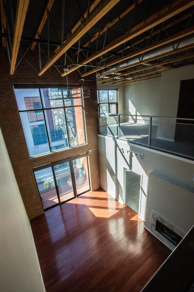 interior space featuring wood-type flooring and a towering ceiling