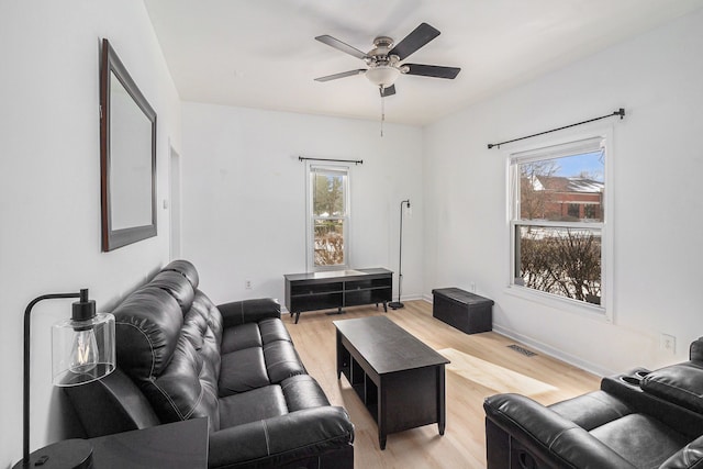 living room with light hardwood / wood-style floors and ceiling fan