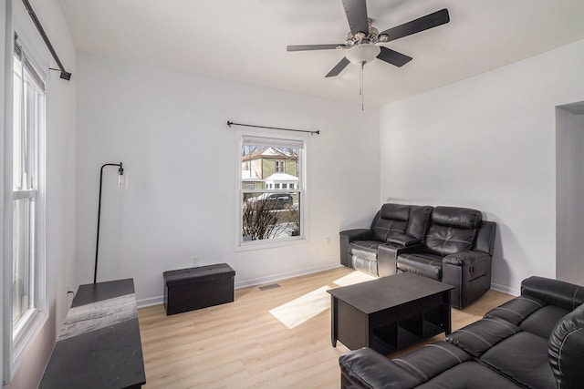 living room with ceiling fan and light hardwood / wood-style floors