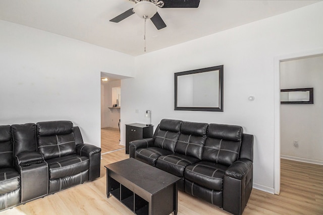 living room featuring ceiling fan and light hardwood / wood-style flooring