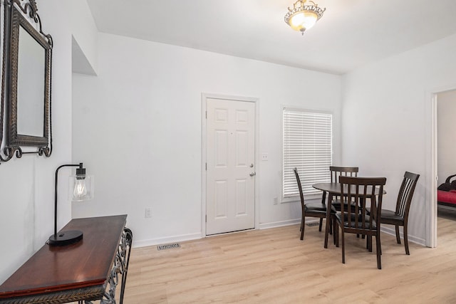 dining space with light hardwood / wood-style floors