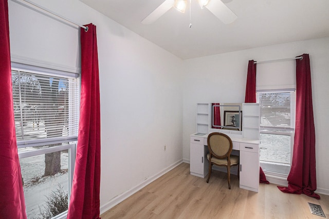 office with light hardwood / wood-style floors and ceiling fan