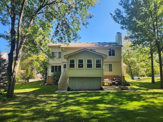 rear view of property with a patio area and a yard