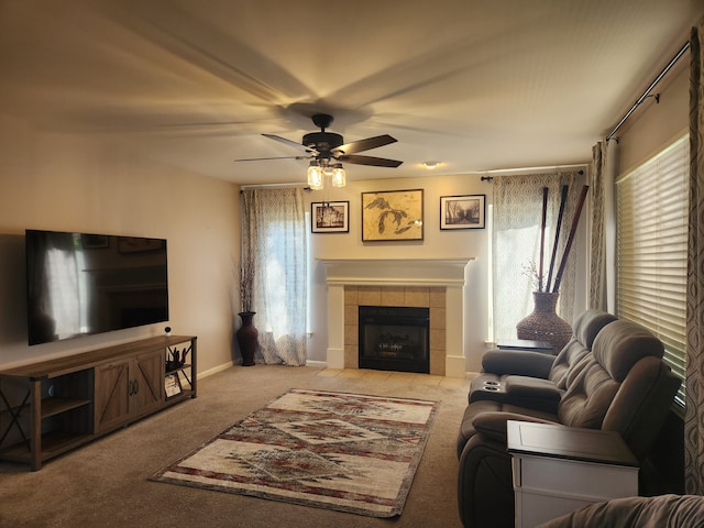 carpeted living room with a tile fireplace, ceiling fan, and a healthy amount of sunlight