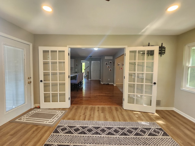 doorway with hardwood / wood-style floors and french doors