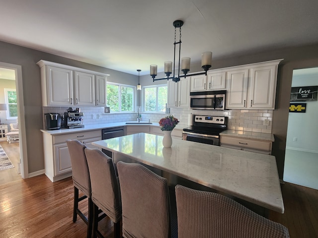 kitchen featuring plenty of natural light, sink, white cabinetry, and stainless steel appliances