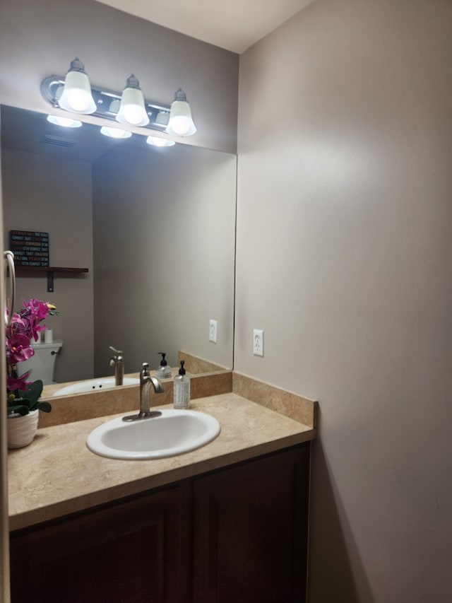 bathroom with vanity and toilet