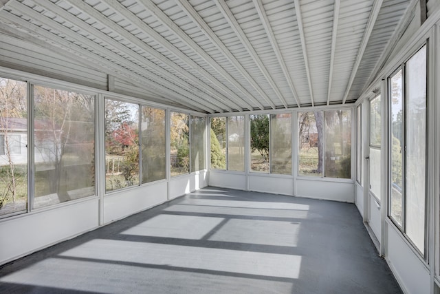 unfurnished sunroom featuring plenty of natural light and vaulted ceiling