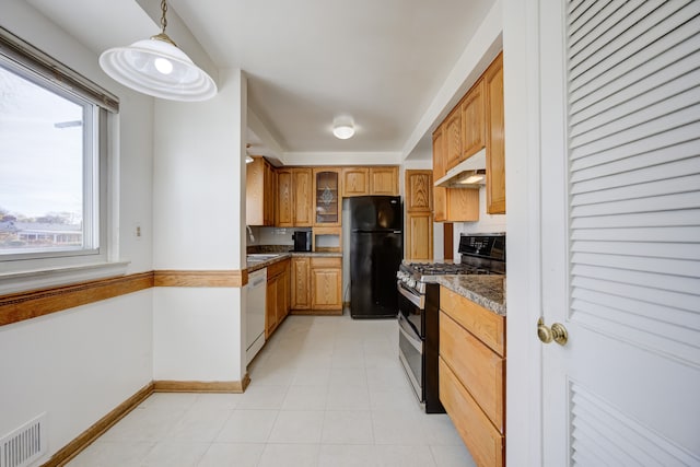 kitchen featuring black fridge, white dishwasher, dark stone countertops, hanging light fixtures, and stainless steel range with gas stovetop