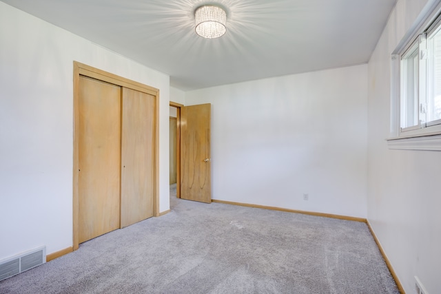 unfurnished bedroom with carpet and a closet