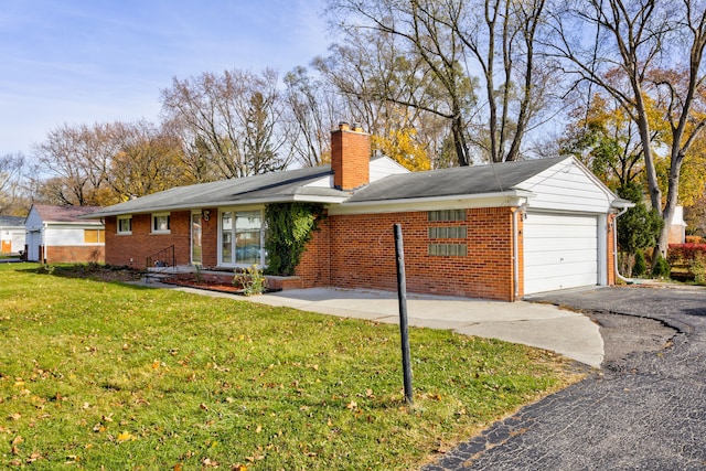 ranch-style home with a front lawn and a garage