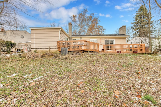 back of property featuring central AC and a deck