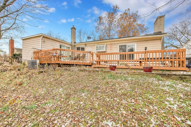 back of property featuring central air condition unit and a wooden deck