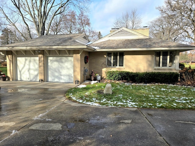 view of front of house with a garage and a front lawn