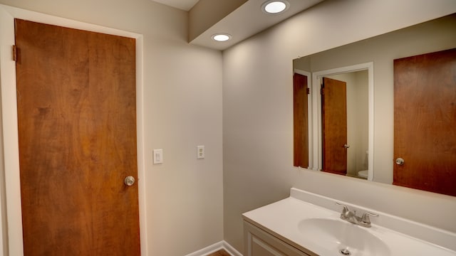 bathroom with vanity and toilet