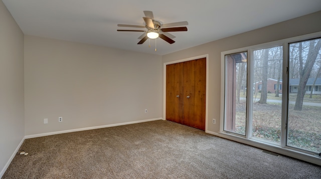 empty room with ceiling fan and carpet