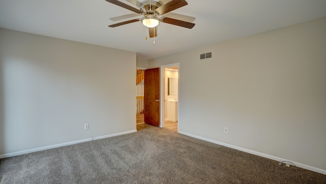 carpeted spare room featuring ceiling fan