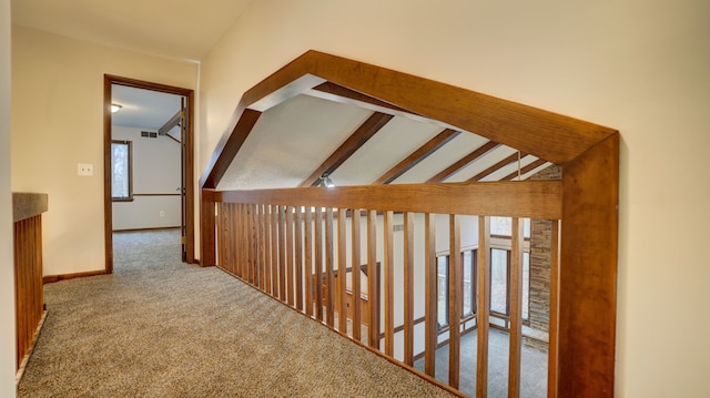 corridor featuring carpet floors and lofted ceiling with beams