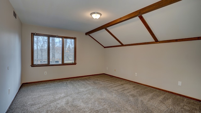 interior space with carpet flooring and vaulted ceiling with beams