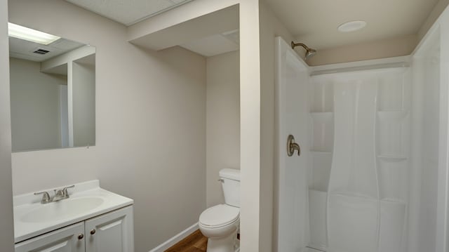 bathroom featuring hardwood / wood-style floors, vanity, toilet, and walk in shower