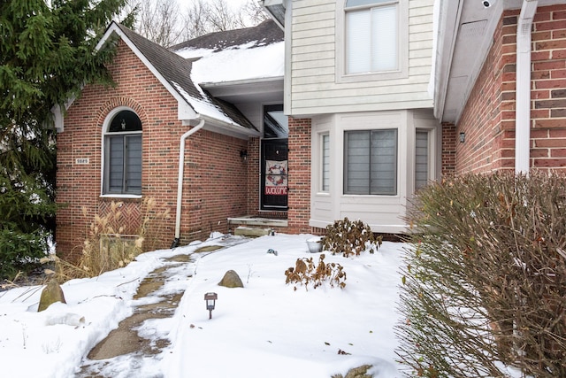 view of snow covered property entrance