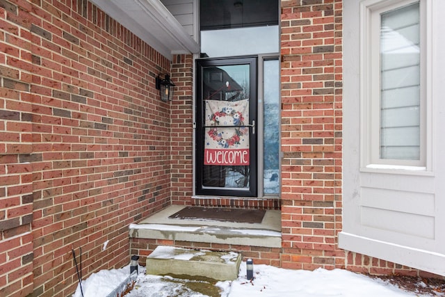 view of snow covered property entrance