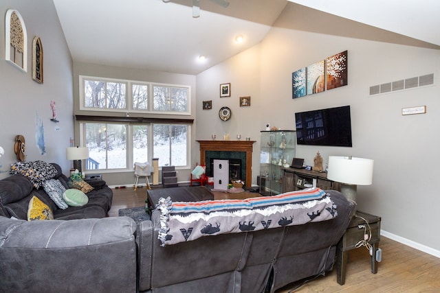 living room featuring light hardwood / wood-style floors and vaulted ceiling