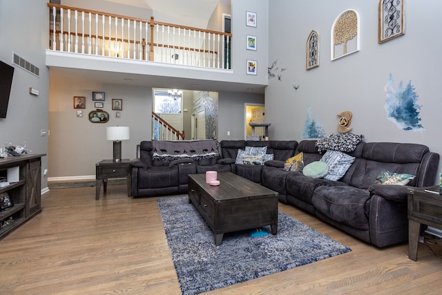 living room featuring a high ceiling and hardwood / wood-style flooring