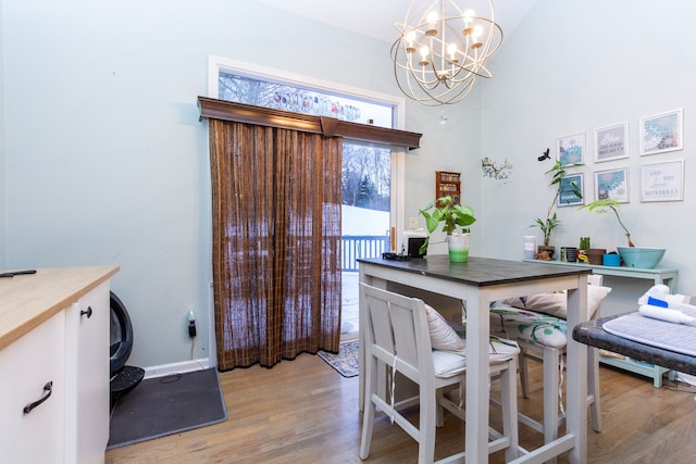 dining area featuring an inviting chandelier and light hardwood / wood-style flooring