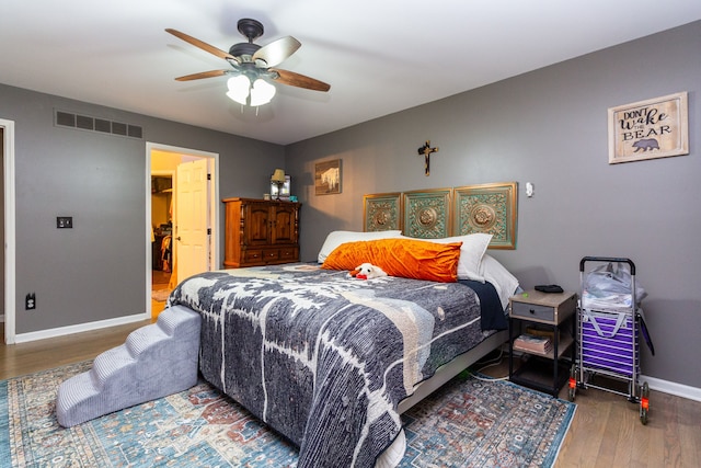 bedroom with hardwood / wood-style floors and ceiling fan