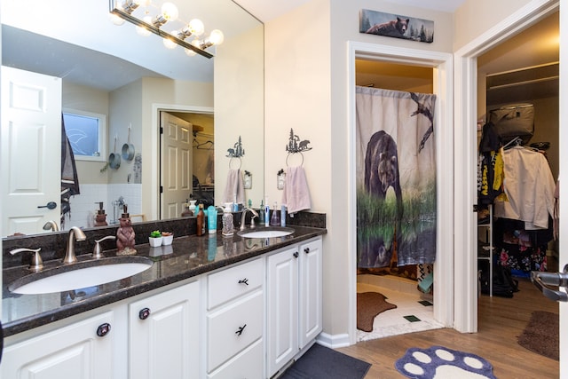 bathroom with hardwood / wood-style floors and vanity