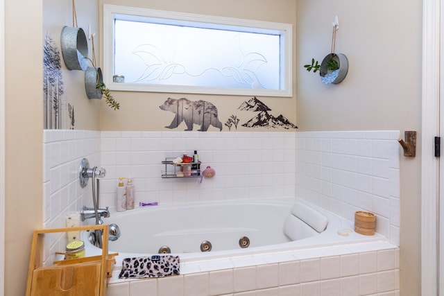 bathroom featuring tiled bath and a wealth of natural light