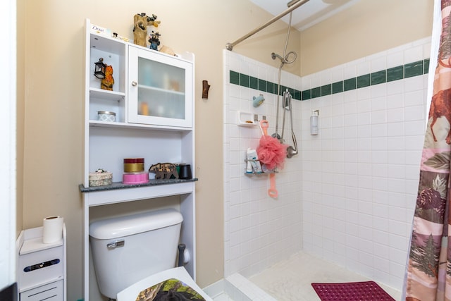 bathroom with a shower with curtain and toilet