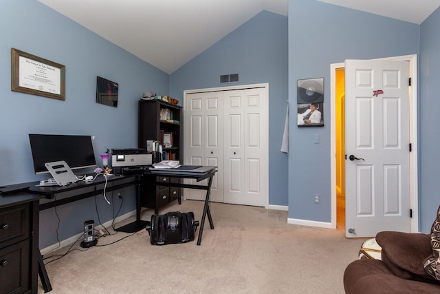 carpeted office with vaulted ceiling