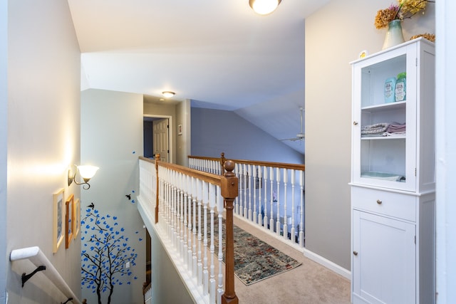 corridor with carpet flooring and lofted ceiling