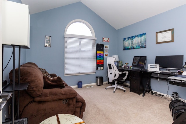 carpeted home office with lofted ceiling