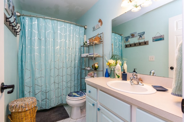 bathroom with tile patterned floors, curtained shower, vanity, and toilet