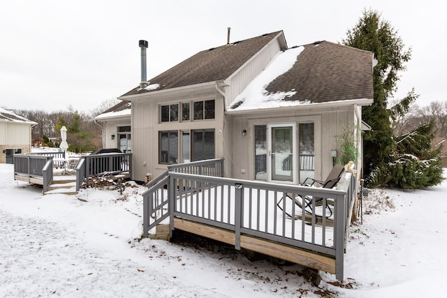 snow covered property featuring a deck