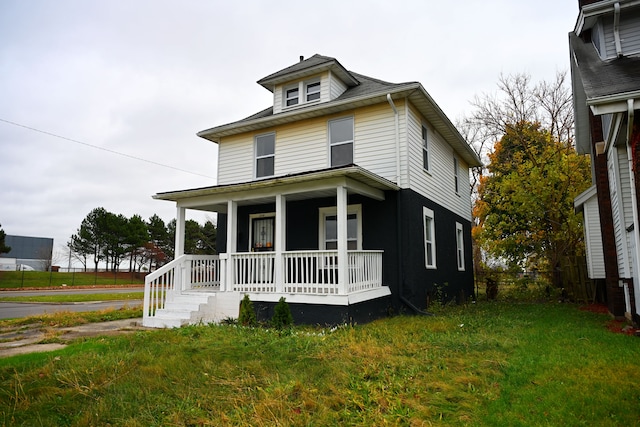 view of front of home featuring a front lawn and covered porch