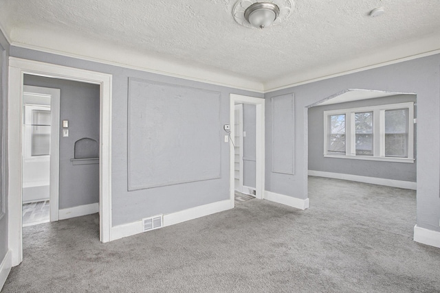 carpeted spare room featuring a textured ceiling