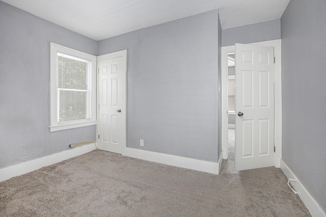 unfurnished room featuring light carpet