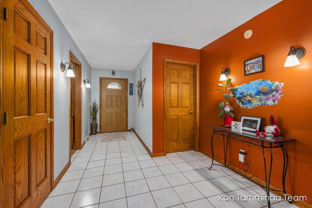 foyer featuring light tile patterned floors and baseboards