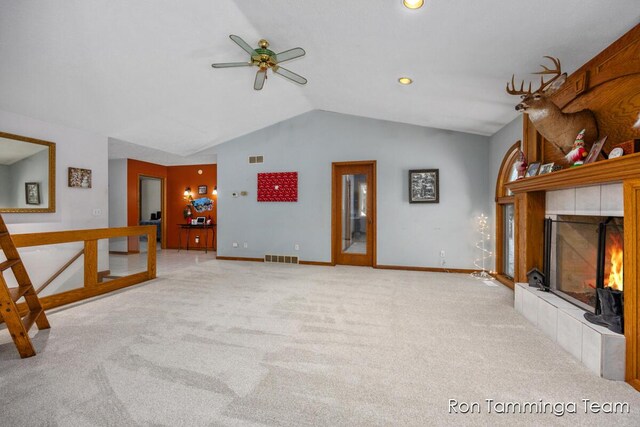 2187 Riley St, Hudsonville, MI 49426 - unfurnished living room featuring lofted ceiling, ceiling fan, carpet floors, baseboards, and a tile fireplace