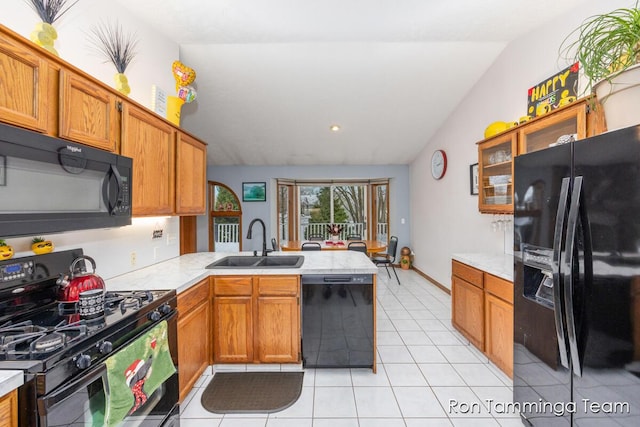 2187 Riley St, Hudsonville, MI 49426 - kitchen with black appliances, a sink, a peninsula, lofted ceiling, and light countertops