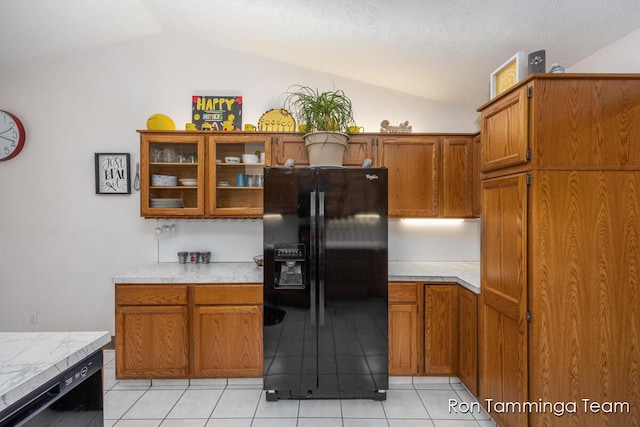 2187 Riley St, Hudsonville, MI 49426 - kitchen with black appliances, lofted ceiling, brown cabinetry, glass insert cabinets, and light tile patterned floors