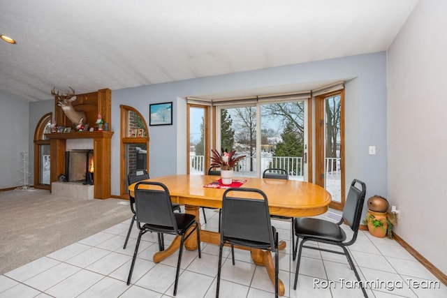 2187 Riley St, Hudsonville, MI 49426 - dining room with a lit fireplace and baseboards