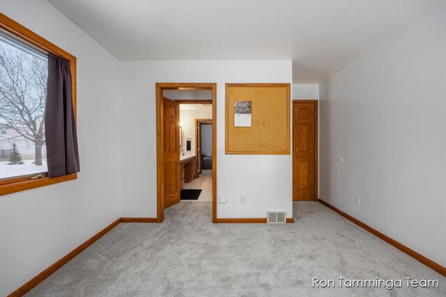 2187 Riley St, Hudsonville, MI 49426 - unfurnished bedroom featuring baseboards and carpet flooring