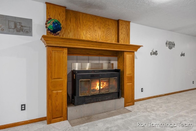 2187 Riley St, Hudsonville, MI 49426 - detailed view of a tiled fireplace, carpet floors, baseboards, and a textured ceiling