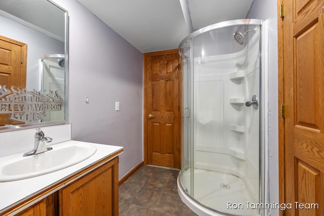 2187 Riley St, Hudsonville, MI 49426 - bathroom with a stall shower, vanity, baseboards, and stone finish flooring