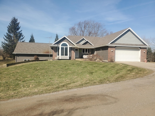 ranch-style home featuring a front yard, brick siding, a garage, and driveway